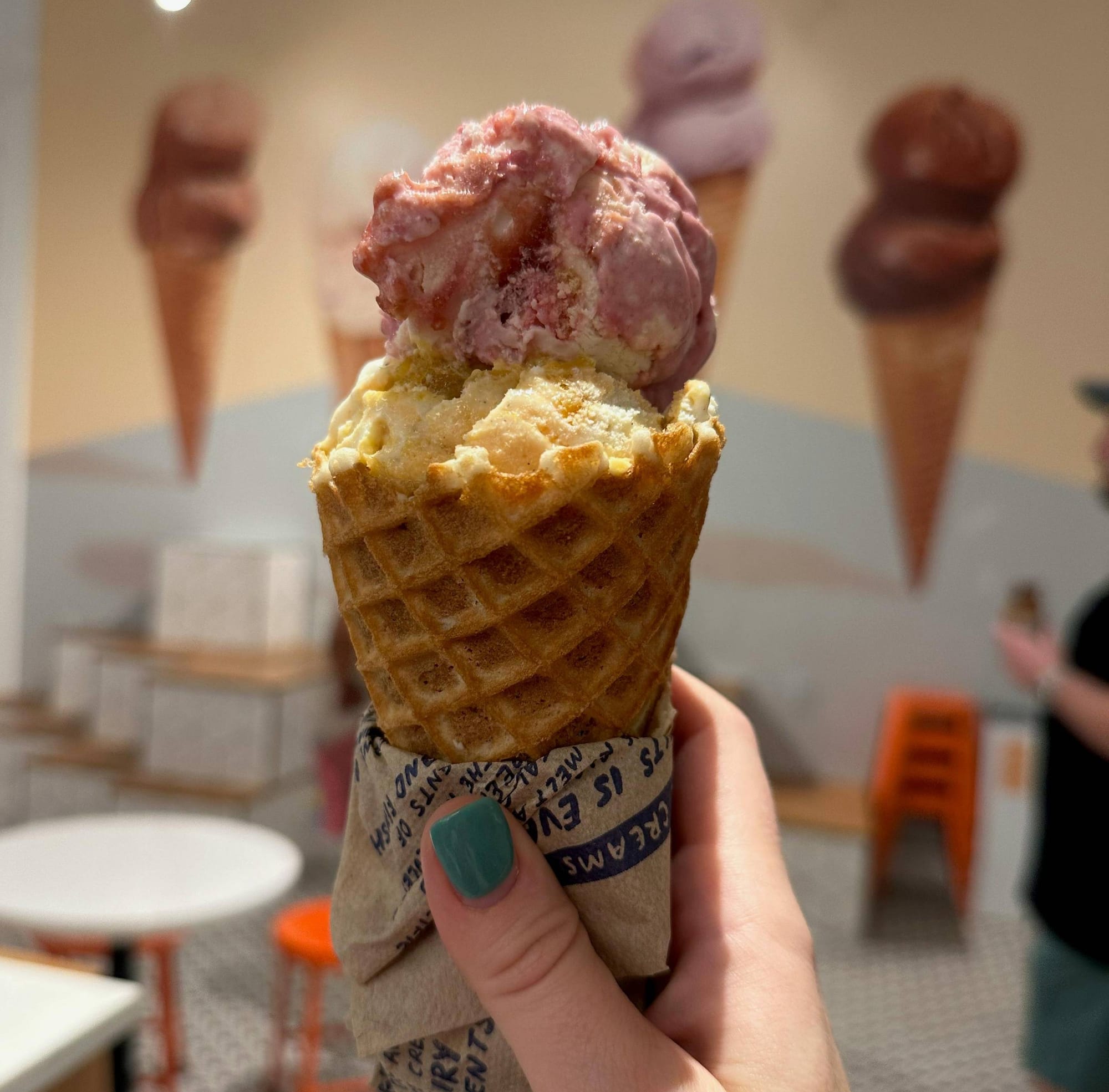 A hand holding an ice-cream cone